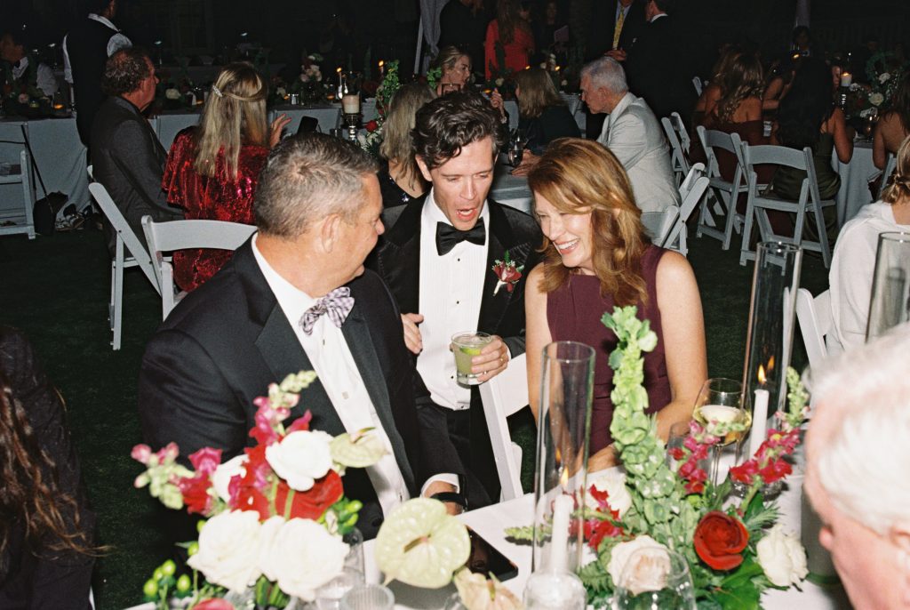 groom talks with wedding guests